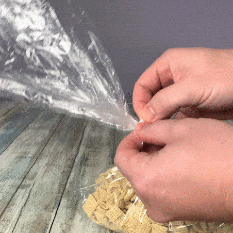 Person opening a sealed poly bag